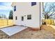 Side of home with concrete patio, white siding, and a light-colored wood fence surrounding the property at 624 W Kerr St, Salisbury, NC 28144