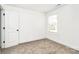 Bright bedroom featuring neutral carpet, baseboards, fresh paint, and a large window at 624 W Kerr St, Salisbury, NC 28144