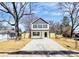 Welcoming two-story home highlighting a wood fence, long driveway, tidy landscaping, and mature trees at 624 W Kerr St, Salisbury, NC 28144