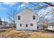 Rear view of house showcasing white siding and small patio at 624 W Kerr St, Salisbury, NC 28144