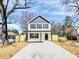 Charming two-story home with a long driveway, black shutters, black trim, and wood fence at 624 W Kerr St, Salisbury, NC 28144