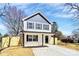 Inviting two-story home featuring a wood fence, black shutters, black trim, and a concrete driveway at 624 W Kerr St, Salisbury, NC 28144