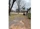 Exterior shot of a home and large grassy yard with a shed and driveway at 805 Railroad Ave, China Grove, NC 28023