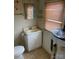 Bathroom with standard sink, toilet, and a window letting in natural light at 805 Railroad Ave, China Grove, NC 28023