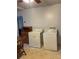 Area near kitchen shows laundry machines and a wooden cabinet for storage at 805 Railroad Ave, China Grove, NC 28023