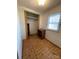 Small room with tiled floors, closet, and a window with natural light at 805 Railroad Ave, China Grove, NC 28023