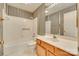 The bathroom features striped wallpaper, a combined shower and tub, and a wood vanity with a sink at 8218 Legare Ct, Charlotte, NC 28210