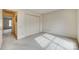 Carpeted bedroom featuring a closet with bi-fold doors and a doorway with a view into another room at 8218 Legare Ct, Charlotte, NC 28210