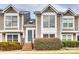 Charming two-story townhome with a brick entryway and well-maintained landscaping, creating a welcoming curb appeal at 8218 Legare Ct, Charlotte, NC 28210