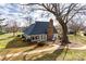 Back exterior of home with a paved walkway, patio furniture, and a dark shingled roof at 8218 Legare Ct, Charlotte, NC 28210