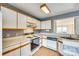 Functional kitchen with ample counter space, white cabinets, and updated appliances, ready for culinary creations at 8218 Legare Ct, Charlotte, NC 28210