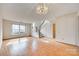 Spacious living area with hardwood floors, a staircase, a chandelier, and abundant natural light, great for gatherings at 8218 Legare Ct, Charlotte, NC 28210