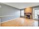 Cozy living room featuring a brick fireplace, hardwood floors, and an inviting atmosphere for relaxation and entertainment at 8218 Legare Ct, Charlotte, NC 28210