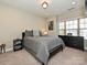 Cozy bedroom with gray bedding, a dresser, and large window at 946 Emory Ln, Fort Mill, SC 29708