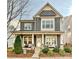 Two story home with gray siding, stone accents, and a front porch at 946 Emory Ln, Fort Mill, SC 29708