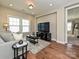 Living room with hardwood floors, sofa, and built-in entertainment center at 946 Emory Ln, Fort Mill, SC 29708