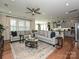 Open living room with hardwood floors, neutral decor, and access to kitchen at 946 Emory Ln, Fort Mill, SC 29708