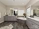 Main bathroom with double vanity, soaking tub, and grey cabinets at 946 Emory Ln, Fort Mill, SC 29708