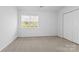 Well-lit bedroom with double doors and carpet at 13660 Meade Glen Ct, Charlotte, NC 28273