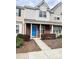 Two-story townhome with brick facade, blue door, and small front yard at 13660 Meade Glen Ct, Charlotte, NC 28273