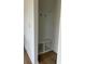 Mudroom with a built-in bench and coat rack, white walls, and hardwood floors at 1476 Hubert Graham Way, Tega Cay, SC 29708