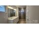Bathroom with dual vanities, large mirror, and a glass-enclosed shower at 159 Ella Claire Dr, York, SC 29745