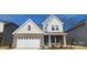 Charming two-story home featuring a brick facade, attached garage, and inviting front porch at 159 Ella Claire Dr, York, SC 29745