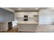 Bright kitchen with white cabinets, granite countertops, stainless steel appliances, and large kitchen island at 159 Ella Claire Dr, York, SC 29745