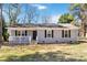 Single-story home with grey siding, black shutters, and a small porch at 1637 Sumner Dr, Rock Hill, SC 29732