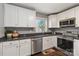 Well-lit kitchen with white cabinets, stainless steel appliances and black countertops at 1637 Sumner Dr, Rock Hill, SC 29732