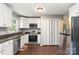 Bright kitchen featuring white cabinets, stainless steel appliances, and a side-by-side refrigerator at 1637 Sumner Dr, Rock Hill, SC 29732