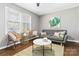 Inviting living room featuring a gray sofa, decorative art, and natural light from the window at 1637 Sumner Dr, Rock Hill, SC 29732