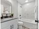 Modern bathroom with gray vanity and marble tile at 2000 Patio Ct # 129, Charlotte, NC 28205