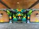 Covered common area with geometric mural and a bench for residents at 2000 Patio Ct # 129, Charlotte, NC 28205