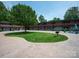 Community courtyard with green space, fire pit, and seating at 2000 Patio Ct # 129, Charlotte, NC 28205