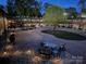 Evening view of a community courtyard with fire pit and seating at 2000 Patio Ct # 129, Charlotte, NC 28205