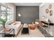 Bright living room with a brick accent wall and stylish decor at 2000 Patio Ct # 129, Charlotte, NC 28205