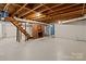 Unfinished basement with brick fireplace and wooden stairs at 2930 W Innes St, Salisbury, NC 28144