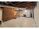 Unfinished basement with brick wall, stairs, and cabinets at 2930 W Innes St, Salisbury, NC 28144