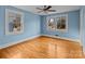 Light blue bedroom with hardwood floors and two windows at 2930 W Innes St, Salisbury, NC 28144