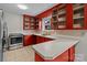 L-shaped kitchen with red cabinets and tile floors at 2930 W Innes St, Salisbury, NC 28144