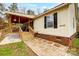 Home's exterior features a covered porch, brick accents, and a landscaped walkway at 4450 Dobys Bridge Rd, Fort Mill, SC 29707