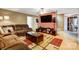 Living room with a brown sectional sofa and a view into the kitchen at 4450 Dobys Bridge Rd, Fort Mill, SC 29707