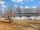 Back exterior of white brick home, with a large backyard at 529 Catalina Dr, Albemarle, NC 28001