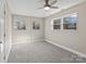 Bedroom features plush carpet, neutral paint, ceiling fan, and two windows at 529 Catalina Dr, Albemarle, NC 28001