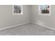 Empty bedroom features two windows, grey carpet and light grey walls at 529 Catalina Dr, Albemarle, NC 28001