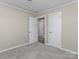 Bedroom with gray carpet, light gray walls, and white doors at 529 Catalina Dr, Albemarle, NC 28001