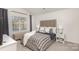 Bright bedroom with a tufted headboard bed and window seat at 7109 N Mills Rd, Charlotte, NC 28216