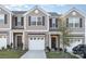 Modern 2-story townhome with attached garage and landscaped front yard at 7109 N Mills Rd, Charlotte, NC 28216