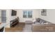 Open living room with sectional sofa and wood-look floors at 7109 N Mills Rd, Charlotte, NC 28216